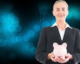 Blonde businesswoman holding piggy bank
