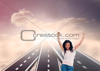 Happy woman with her arms raised up