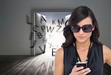 Concentrated brunette wearing sunglasses texting