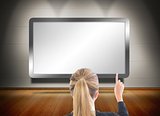 Blonde businesswoman pointing at screen