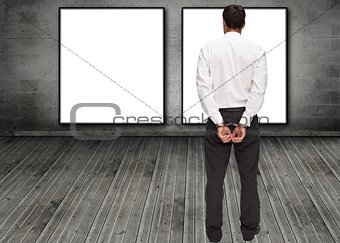 Rear view of young businessman wearing handcuffs