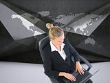 Businesswoman sitting on swivel chair with laptop