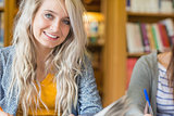 Portrait of a smiling female student at library