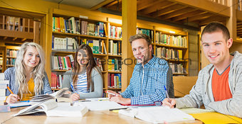 Group portrait of students at college desk