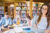 Female student with others in background at library