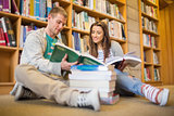 Students reading books on library floor