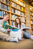 Students reading books on the library floor