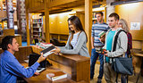 Students in a row at the library counter