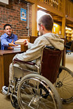 Student in wheelchair at the library counter