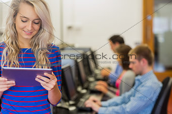 Teacher with students using computers in computer room