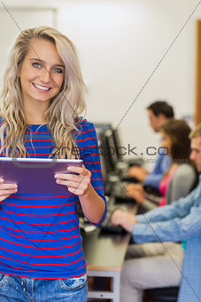 Teacher with students using computers in computer room
