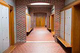 Brick walled corridor with tiled flooring in college