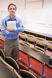 Male teacher with notepad in the lecture hall