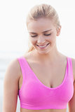 Close up of a smiling healthy woman looking down