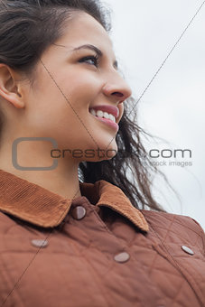 Close up of cute smiling woman in stylish brown jacket