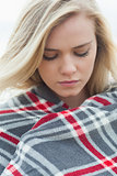 Close up of a young woman covered with blanket