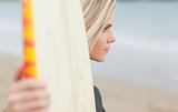 Beautiful woman with surfboard on beach