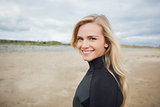 Beautiful woman in wet suit at the beach