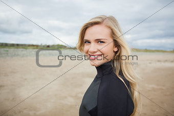 Beautiful woman in wet suit at the beach