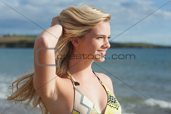 Smiling beautiful young bikini woman at beach