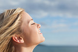 Close up of beautiful woman with eyes closed against sky