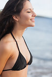Side view of a cute woman with eyes closed at beach