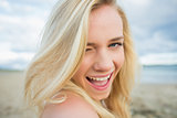 Close up portrait of cheerful relaxed blond at beach