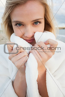 Close up of a woman in stylish white jacket on beach