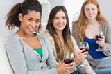 Female friends with wine glasses at home