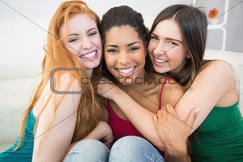 Portrait of happy female friends embracing each other