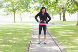 Full length of healthy woman standing on pathway in park