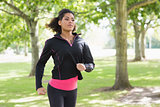 Beautiful healthy young woman jogging in the park