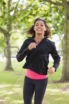 Portrait of a smiling healthy young woman in the park