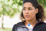 Close up of a tired healthy woman with water bottle in park