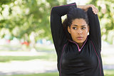 Woman stretching her hands during exercise at park