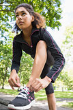 Sporty young woman wearing shoes in park