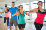 Portrait of fitness class and instructor doing pilates exercise