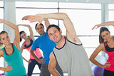 People doing power fitness exercise at yoga class