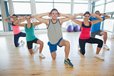 Fitness class and instructor doing pilates exercise