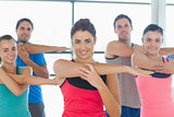 Portrait of sporty people stretching hands at yoga class