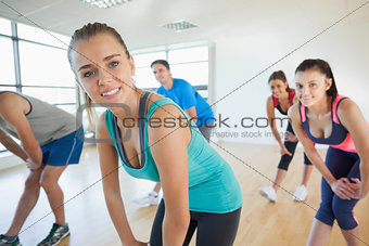 Fitness class and instructor doing power fitness exercise