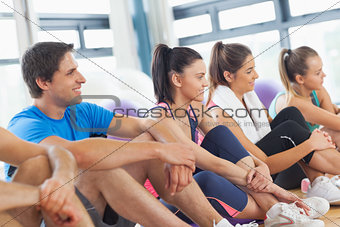 Side view of a group of fitness class sitting in row