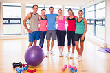 Full length portrait of fitness class at exercise room