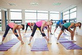 People stretching hands at yoga class in fitness studio