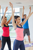 Sporty people doing power fitness exercise at yoga class