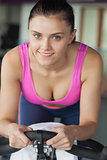 Portrait of a smiling woman working out at spinning class