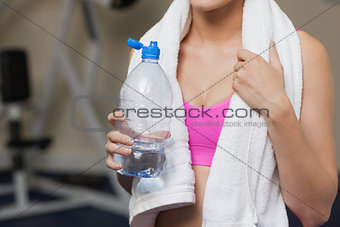 <id section of a woman with water bottle in gym