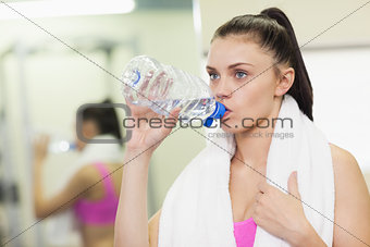 Close up of a woman drinking water in gym