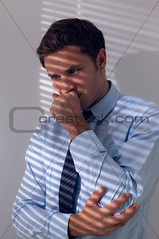 Elegant businessman with a cough against the wall