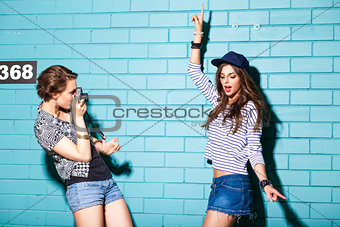 young people having fun in front of light blue brick wall